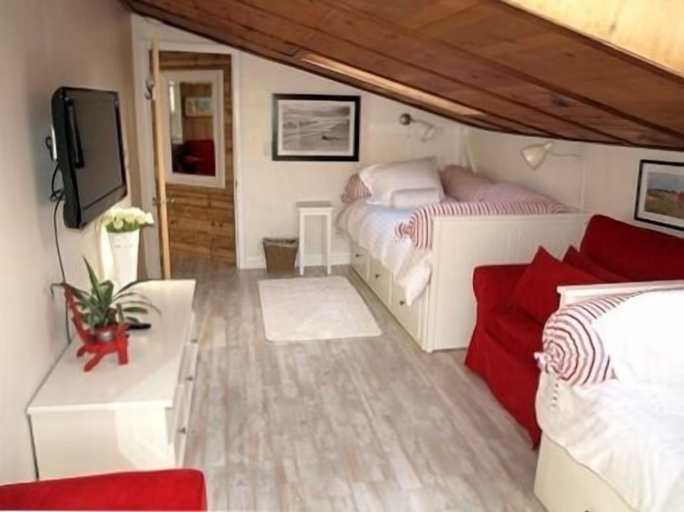 Bedroom with two twin beds, flat screen with DVD player