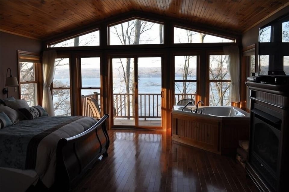 Master Bedroom - Fireplace, Jacuzzi, and balcony over looking lake.  