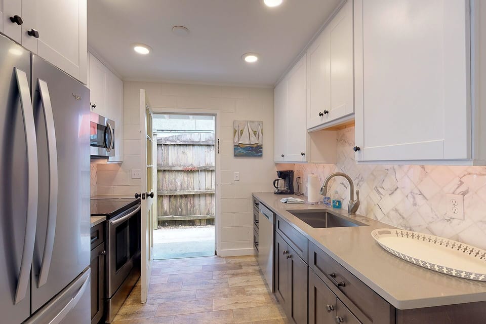 Kitchen has side door that leads to the outdoor shower to the right.