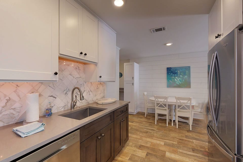 Kitchen has quartz counter tops and top of the line stainless appliances