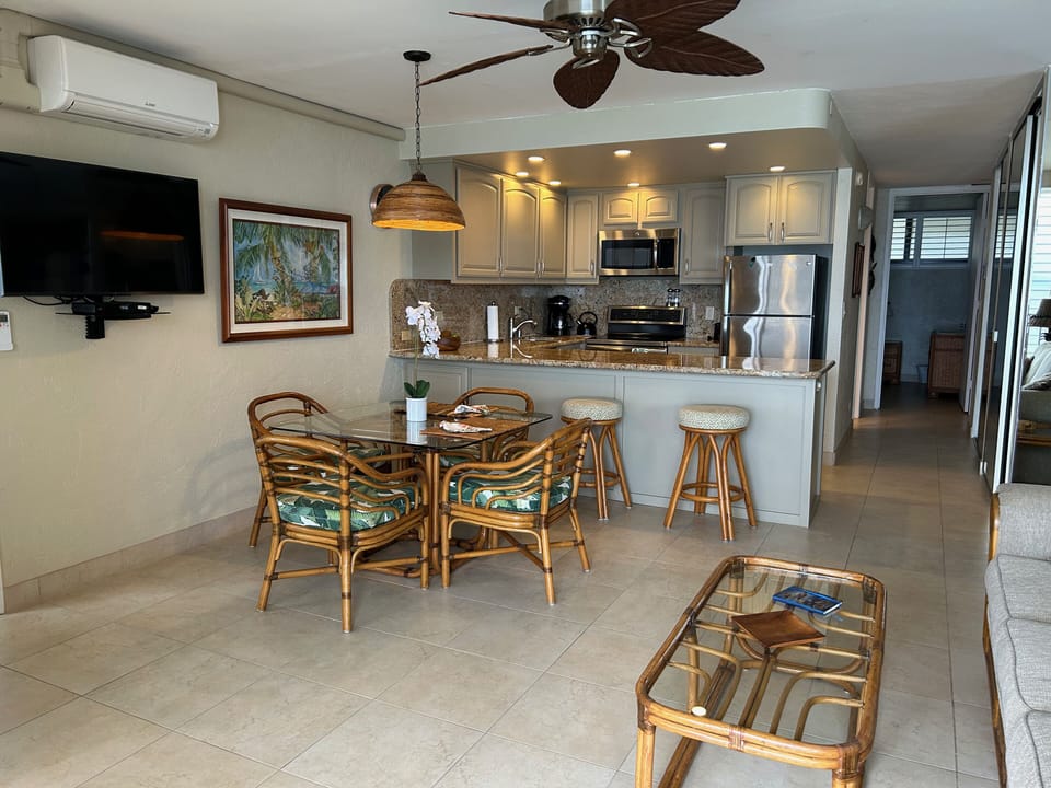 Dining Table and Breakfast Bar stools, Living space AC unit and Smart TV