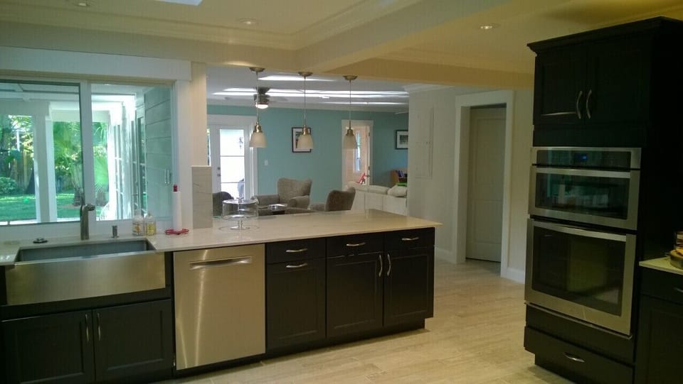 New kitchen has pass-through to pool patio & bar seating in family room