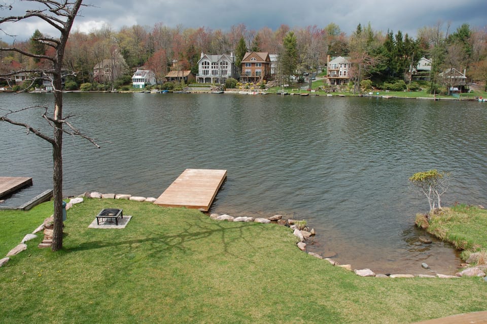 Lakefront yard with large dock and firepit