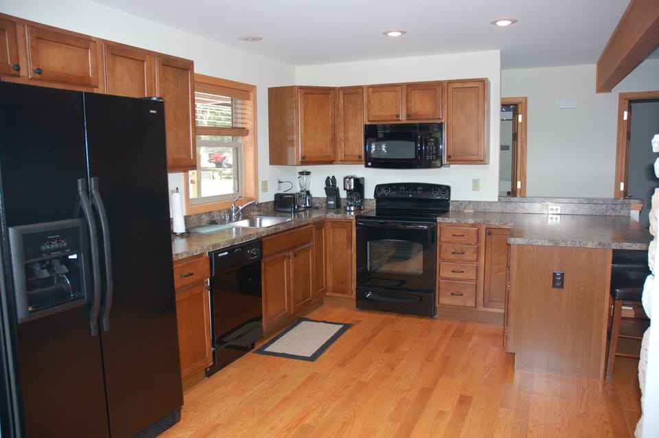 Kitchen with dishwasher, oven, microwave, refrig (w/ ice maker), breakfast bar