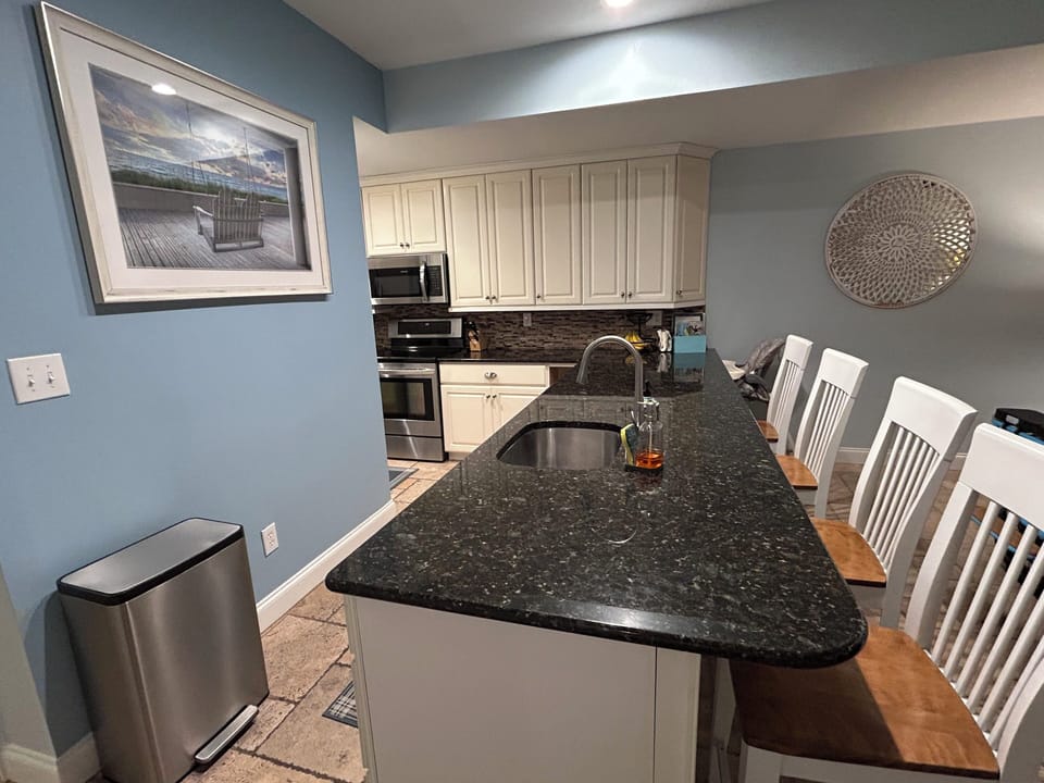 Breakfast bar in kitchen is great location for seating and preparing meals.