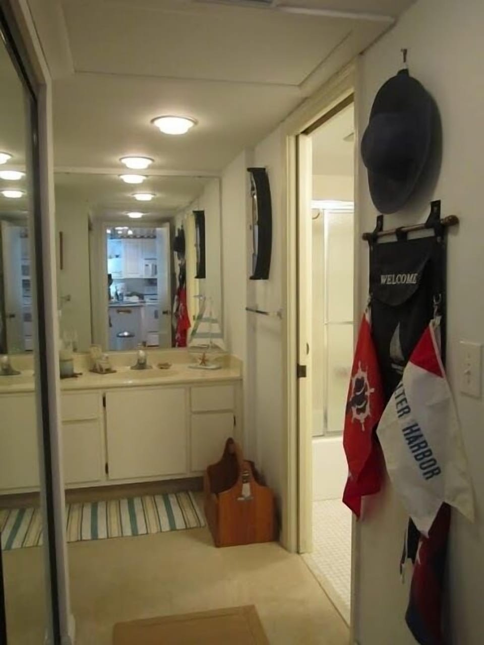 Hallway with additional sink outside of bathroom.