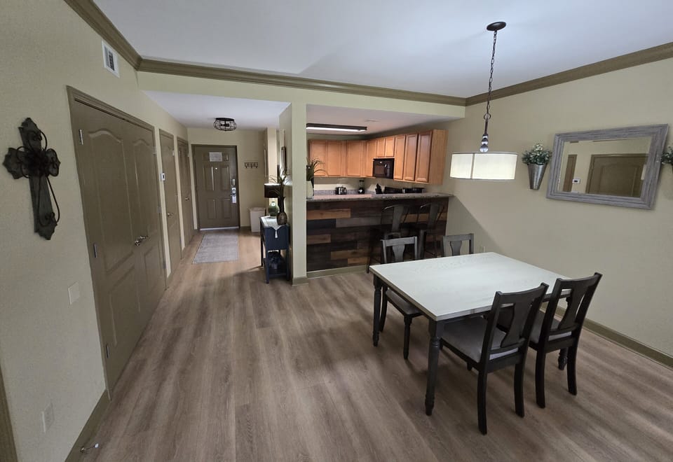 Dining area and twin bunk beds behind french doors