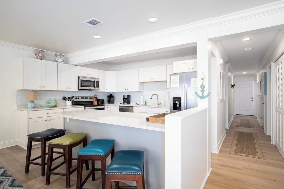 Kitchen is clean and modern design. Prepare food while you look at the beach 