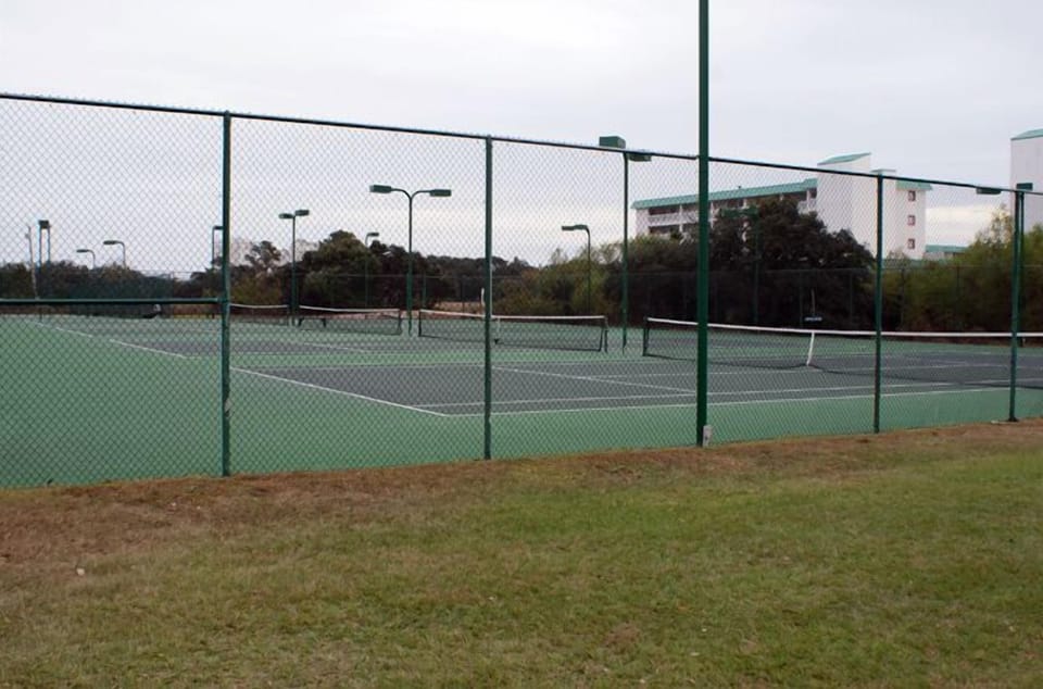 Four of Seven Lit Tennis Courts.