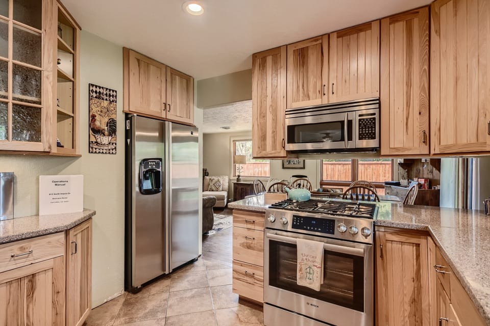 Side by side refrigerator/freezer and gas stove with warming drawer