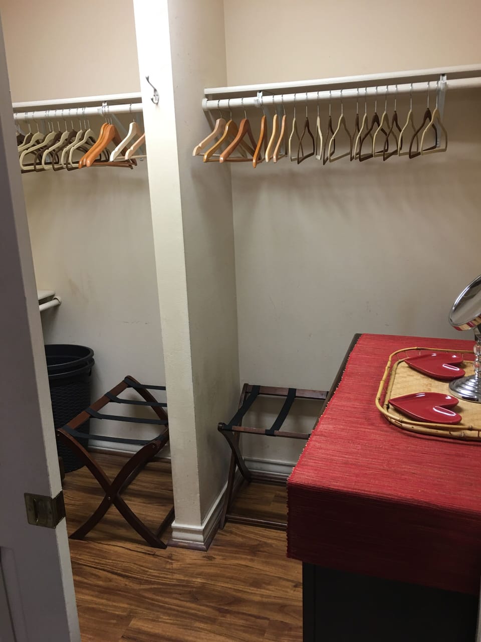 Walk in closet with suitcase racks and extra linens