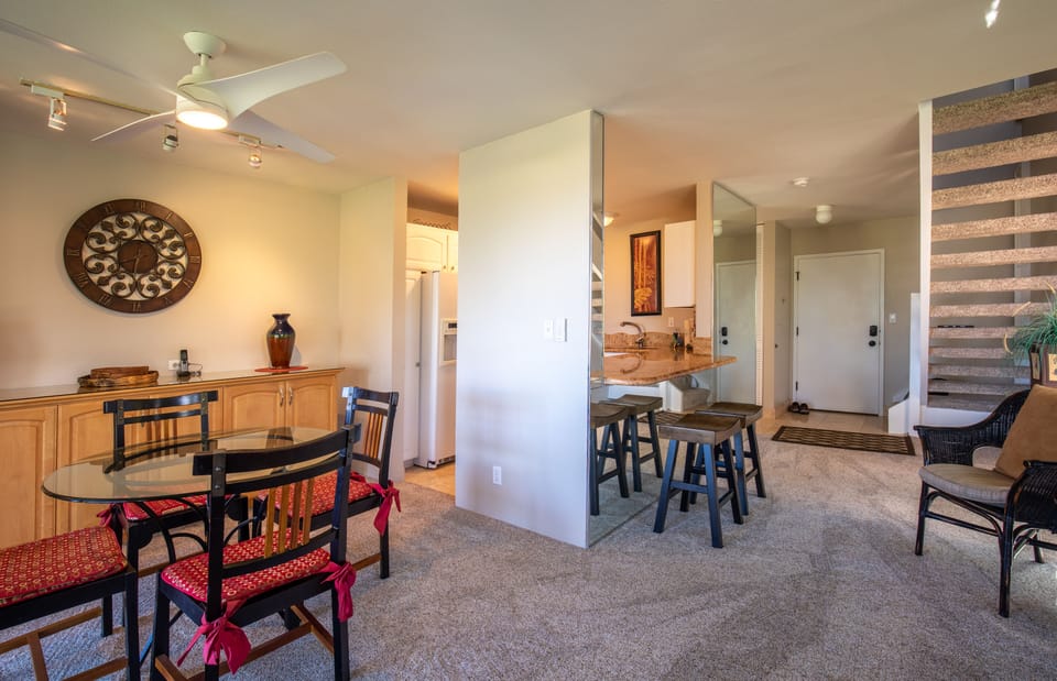 Dining area and open plan kitchen, looking towards the entrance of the condo.
