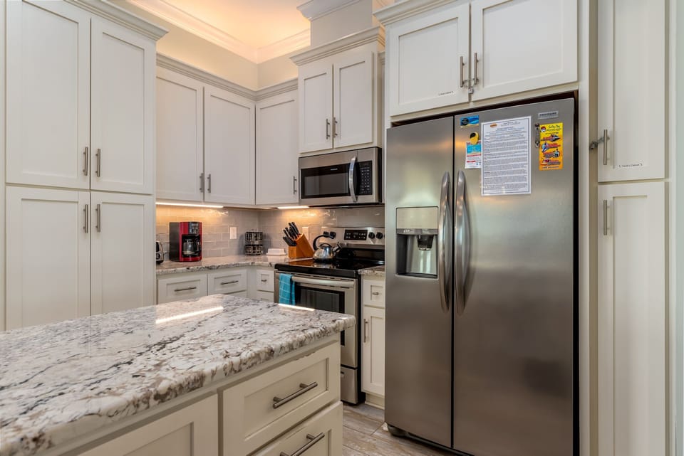 Your fully-equipped gourmet kitchen features marble countertops, stainless steel appliances, and everything you need to create memorable meals during your stay.