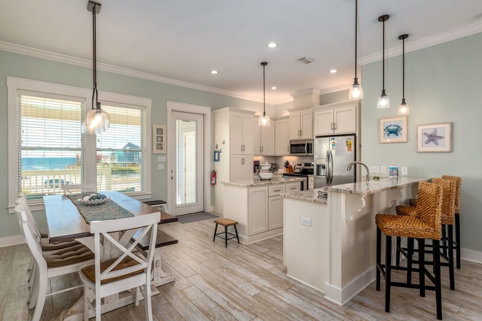 Gather around this coastal-inspired kitchen and dining space where you'll create memories over home-cooked meals and morning coffee.