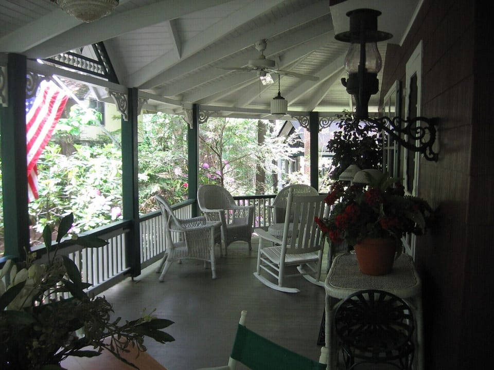 Wrap-around porch with ceiling fans and lots of comfortable places to sit.