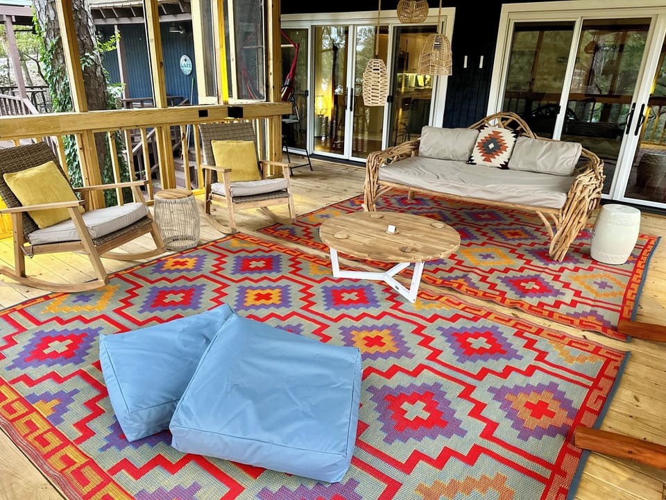 Enjoy the rockers, hammock or daybed on the elevated treehouse screened porch.