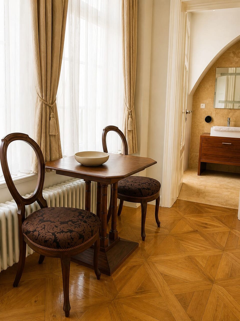 Elegant entrance nook of main apartment with natural light and seating.
