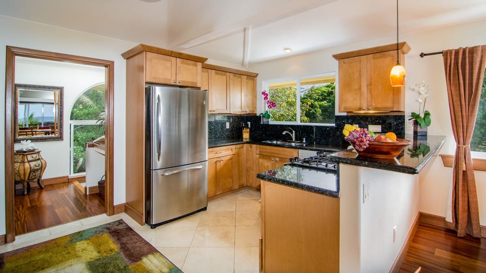 Entry way and kitchen open to dining and living areas.