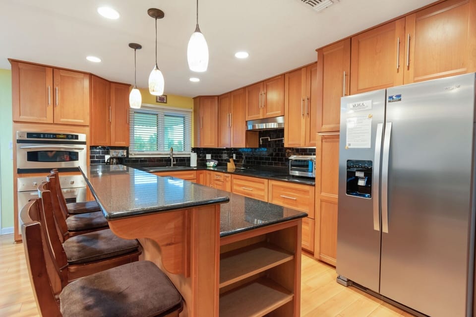 High end SS appliances, custom cabinetry and marble countertops