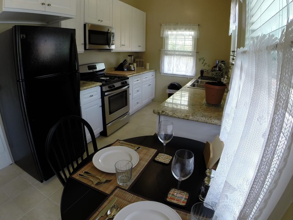 kitchen and dining table, all new top of the line appliances and real tile floor