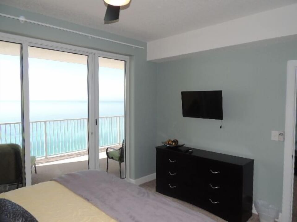 Ocean Front master bedroom; ceiling fan, flat screen cable TV and alarm clock