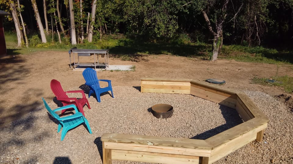 Fire circle with fish cleaning station in the background 