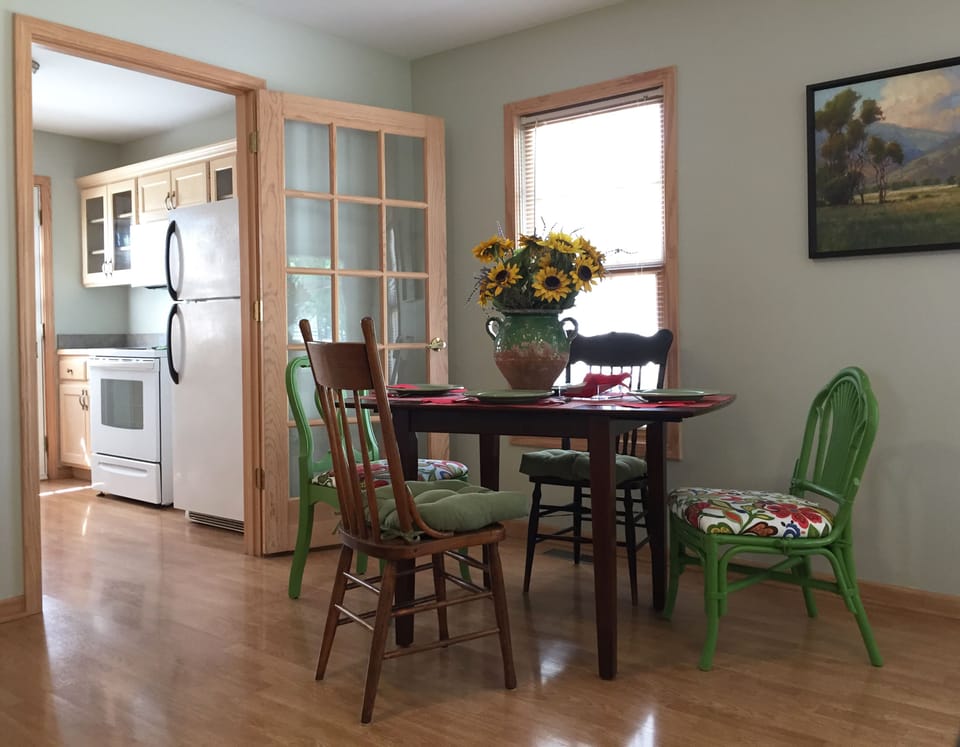 A dining table just outside the kitchen seats four.