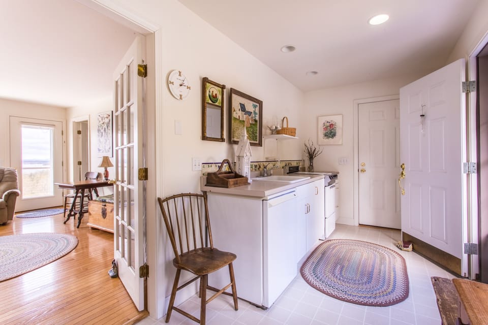 Kitchen entryway with extra fridge and utility sink
