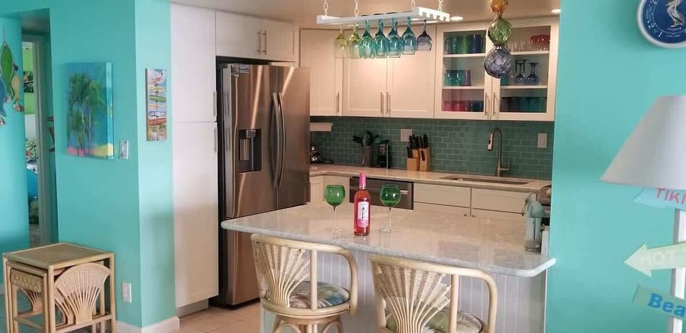 Enjoy a glass of wine by the kitchen bar counter.
