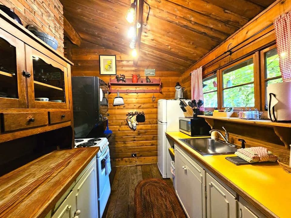 Corridor/Galley kitchen with 4 burner stovetop, oven, microwave, drip coffee maker, knife set, fridge, freezer, cookware, dishes, glassware and more....