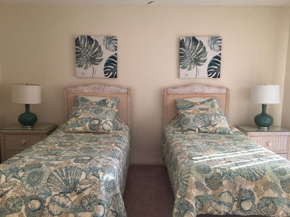 The west bedroom has 2 twin beds. Open the sliding door for a beautiful breeze !