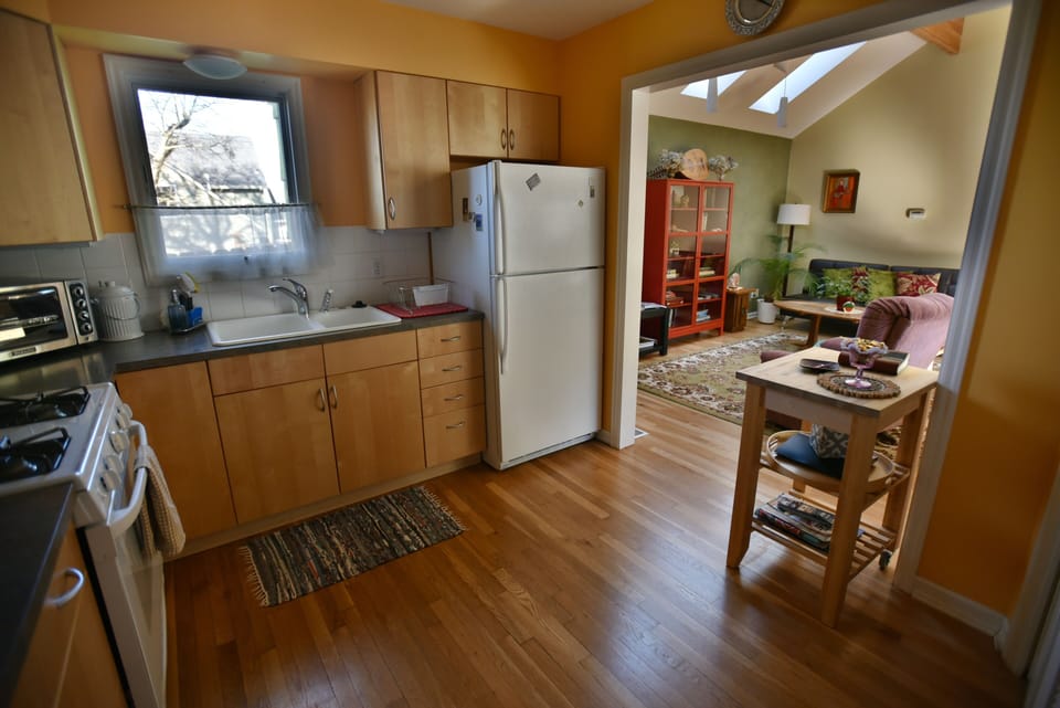 Fully-equipped spacious kitchen with gas range, looking toward living room.