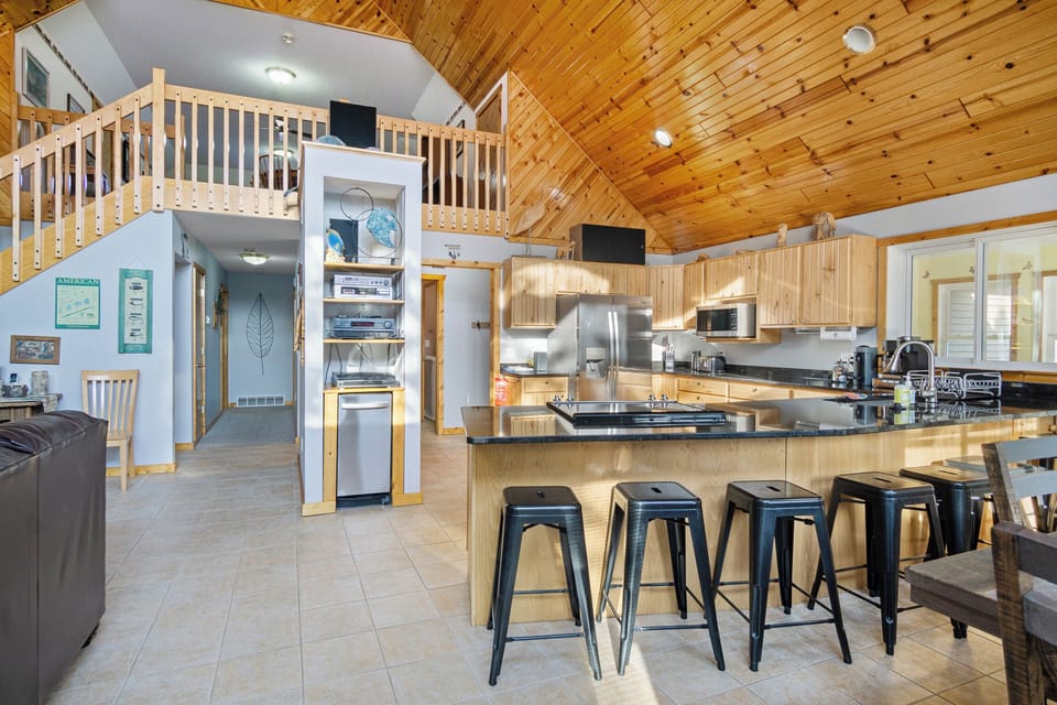Fully equipped kitchen with extra seating at the counter.