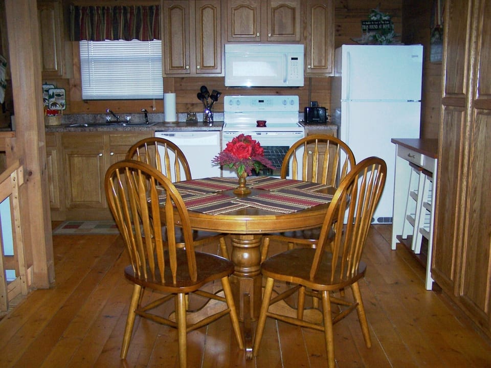 Dining table seats 4 plus breakfast bar with 2 stools adds seating for 2 more.