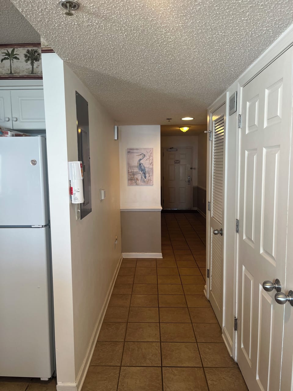 Hallway leading to 3 bedrooms and 2 baths. Laundry and food pantry on right.