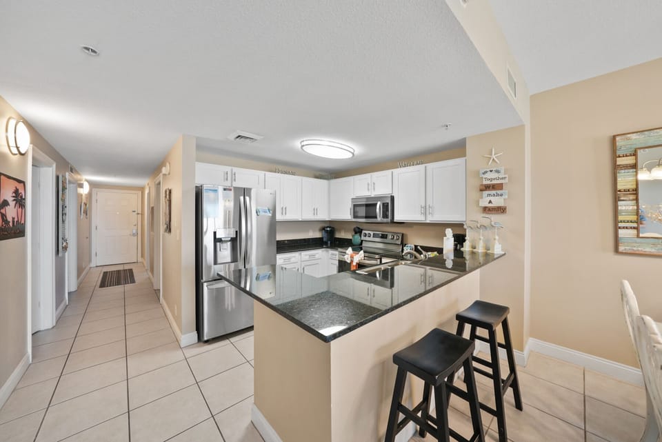 Your fully equipped kitchen features granite counters, stainless appliances, and a breakfast bar where you can sip morning coffee.