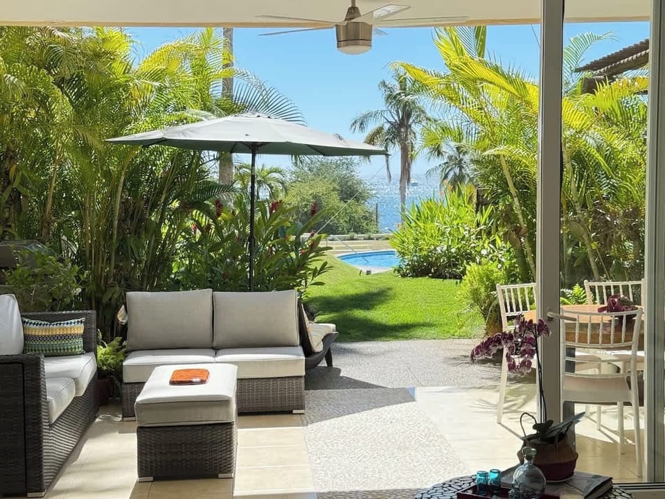 Private beachfront patio with lounge chairs