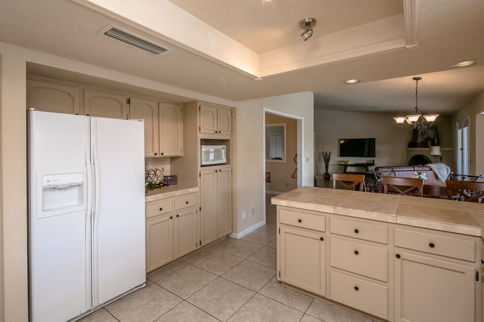 Open Kitchen to nook, living area and backyard pool.