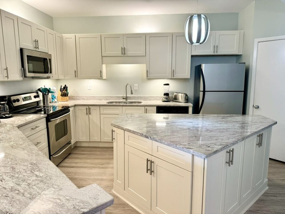 Large, open kitchen with large kitchen island. No more tripping over each other!