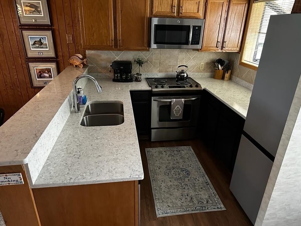 Fresh updated kitchen with quartz counters & Samsung Bespoke fridge.