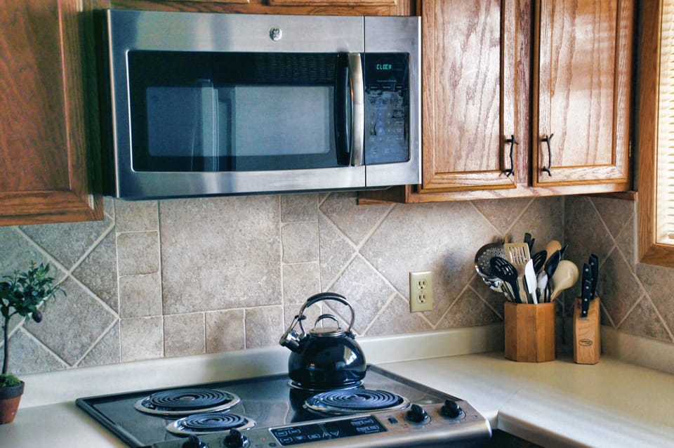 New microwave and plenty of kitchen utensils for cooking like at home.