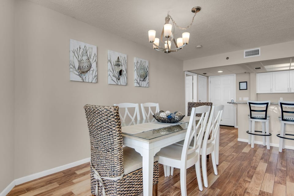 Dining area as seen from balcony side of condo. Open to kitchen area.