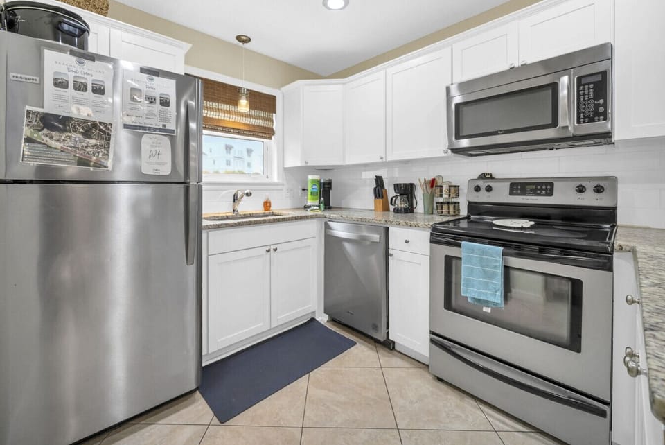 Open, well stocked kitchen with granite countertops, dishwashwer