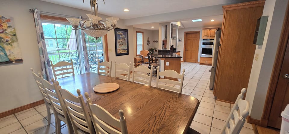kitchen, indoor dining, oven, refrigerator, stovetop, dining table for 10