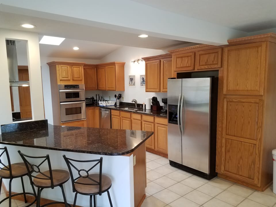 Well stocked kitchen with stainless steel appliances.