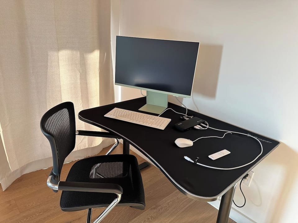 Work from home setup w/ 48” desk, X-Chair, 27” video teleconferencing   smart monitor, thunderbolt docking station, wired keyboard & mouse.