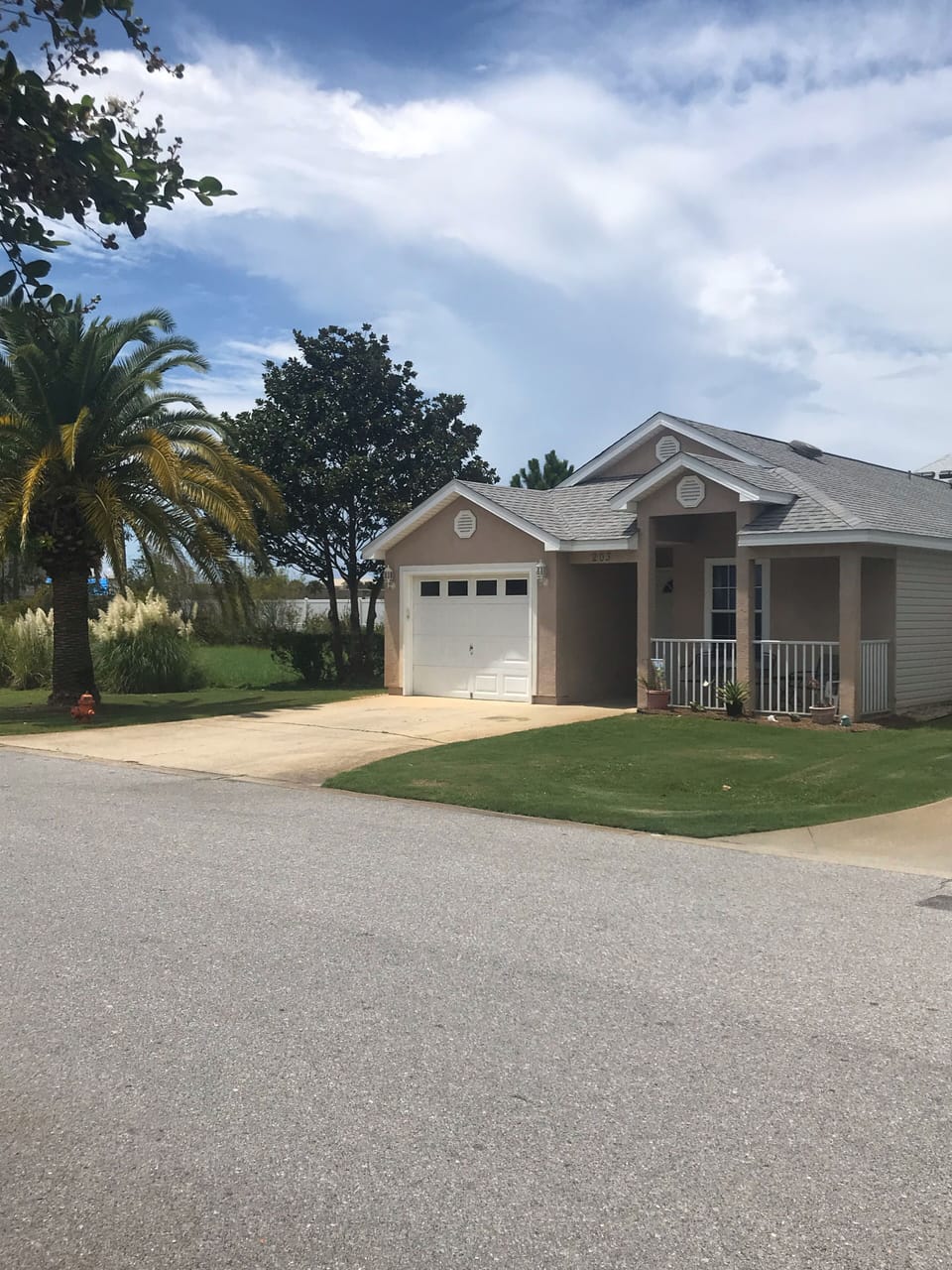 House with room on one side to play cornhole. 