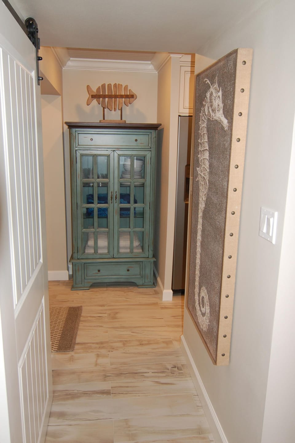 The foyer has a large closet for beach chairs and a beautiful cabinet for towels
