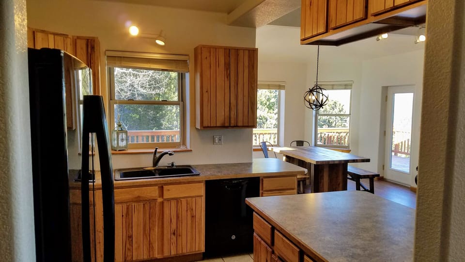 Kitchen complete with dishes, cooking utensils, and pots and pans