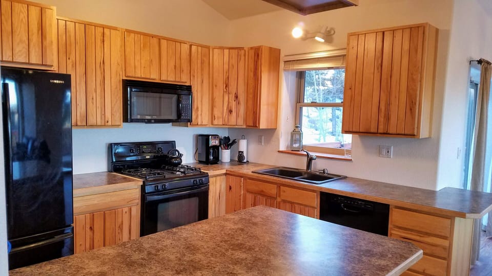Full fridge, gas stove, oven, dishwasher, coffee maker, and microwave